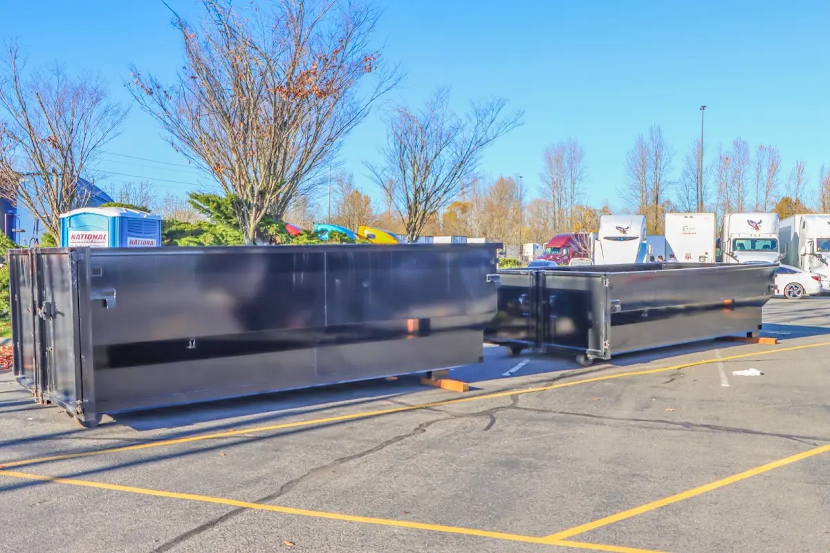 Professional dumpster rental service with roll-off container on residential driveway in Union Beach